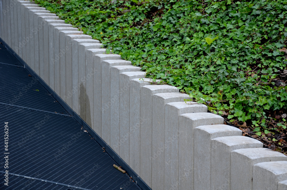 ramp combined with a staircase made of gray concrete and a railing ...