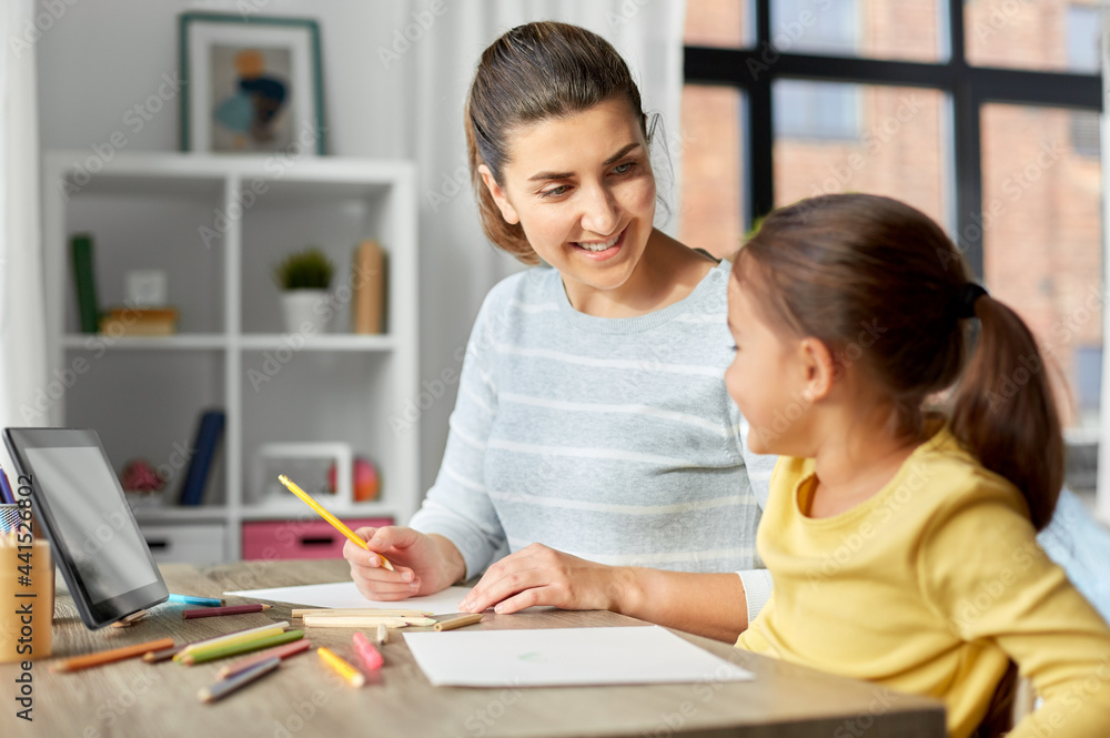family, motherhood and leisure concept - mother spending time with her little daughter drawing with color pencils at home family, motherhood and leisure concept - mother spending time with her little daughter drawing with color pencils at home