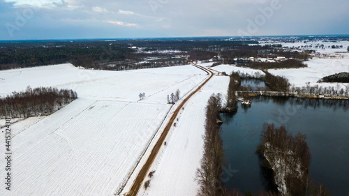 Wallpaper Mural Aerial view with a drone of a spring wavy agricultural countryside landscape with plowed and unplowed fields and trees in the blue evening sky. High quality photo Torontodigital.ca