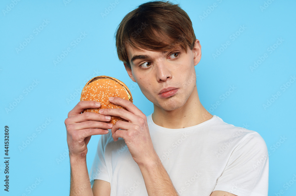 man in white t-shirt hamburger diet food snack lifestyle man in white t-shirt hamburger diet food snack lifestyle