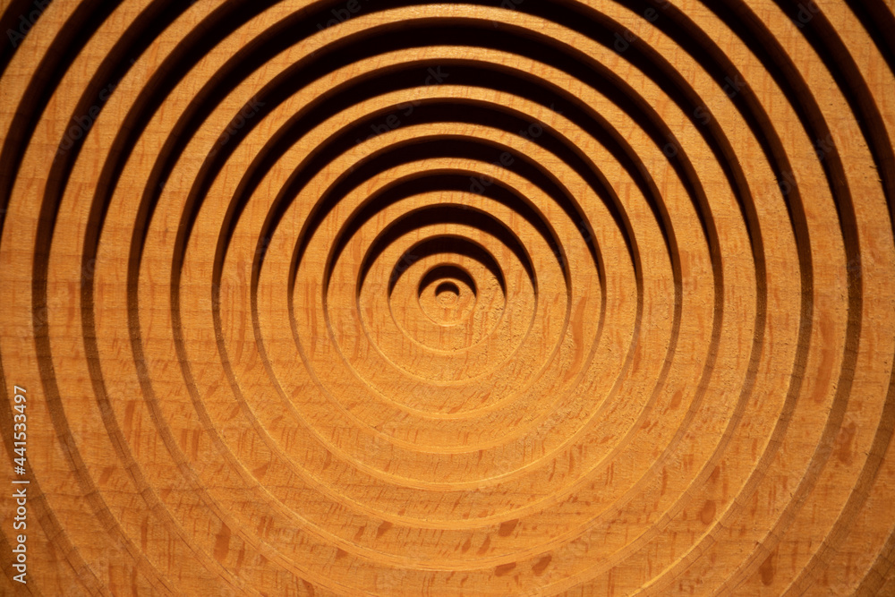 Aerial view of a circular geometric vertical beech wood plate. Concentric round beech wood plate light and shadow. Aerial view of a circular geometric vertical beech wood plate. Concentric round beech wood plate light and shadow.