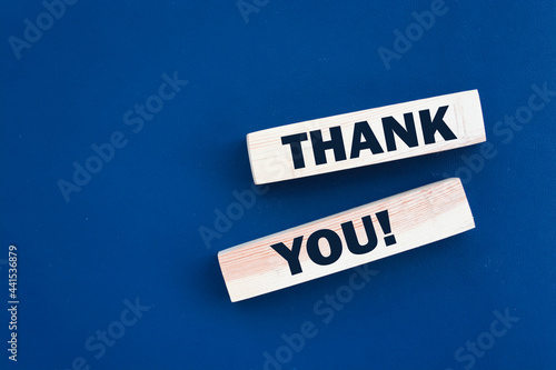 Wooden cubes with the inscription 'thank you'. Beautiful blue background, copy space.