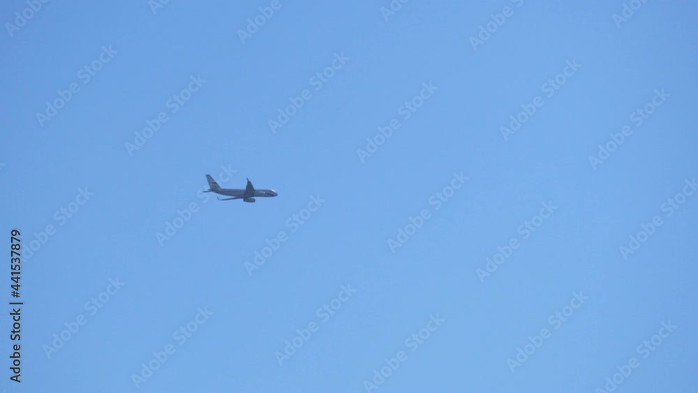 Plane is slowly flying through the blue sky. Travel flight Plane is slowly flying through the blue sky. Travel flight