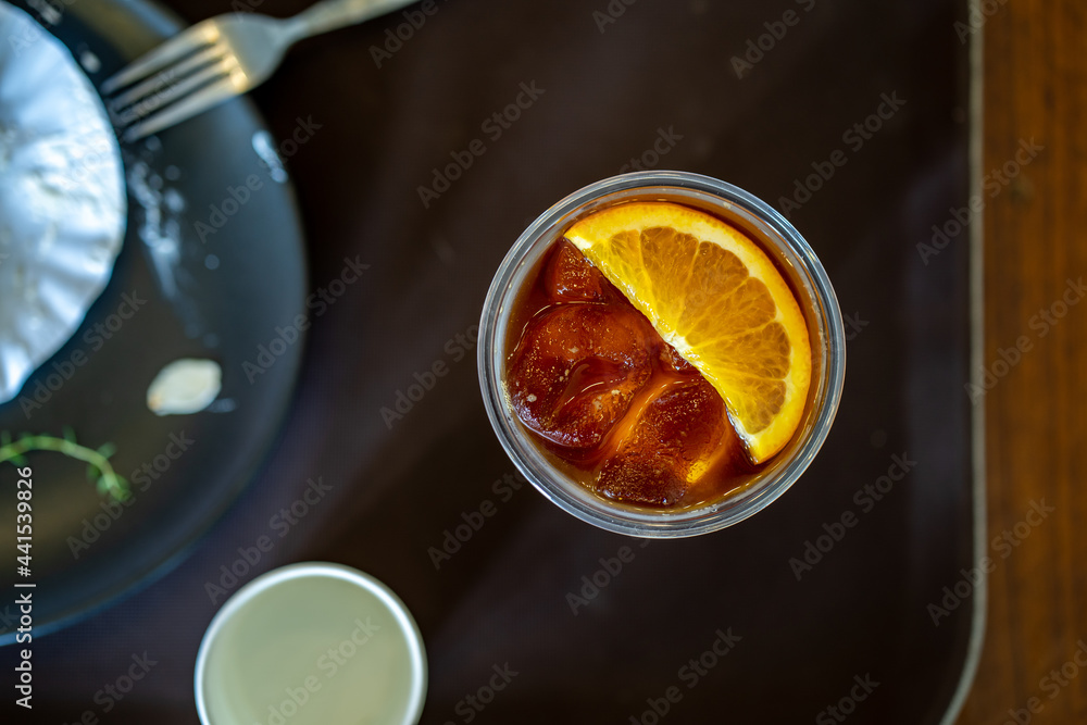 Top view ice orange Americano coffee on table. Top view ice orange Americano coffee on table.