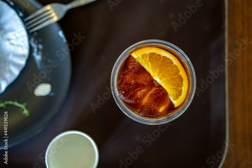 Top view ice orange Americano coffee on table. © tienuskin