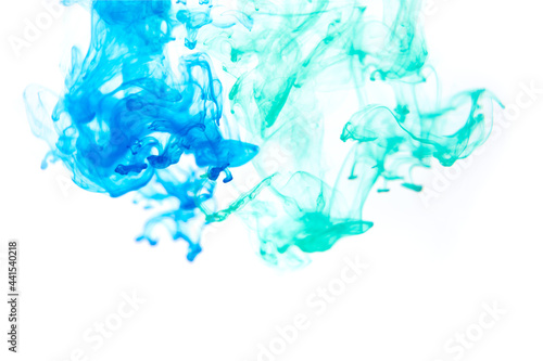 Bright blue and mint acrylic paint swirling in water. Ink moving in liquid creating abstract clouds. Traces of colorful dissolving in water, changing shape. Abstract decorative creative background. © Monstar Studio