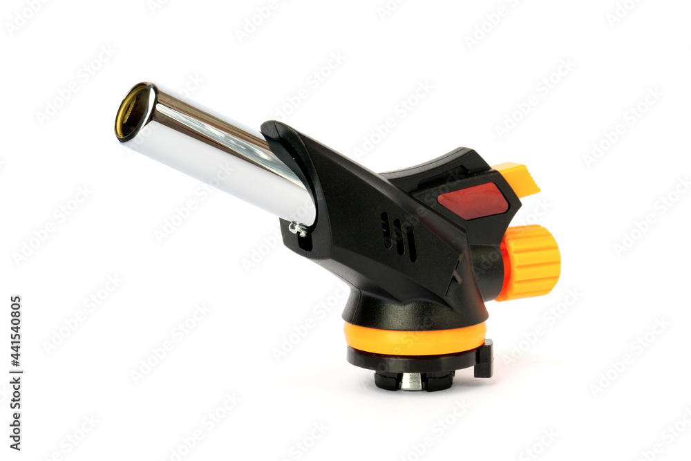 Hand holding a manual gas torch burner blowtorch isolated on a white Hand holding a manual gas torch burner blowtorch isolated on a white
