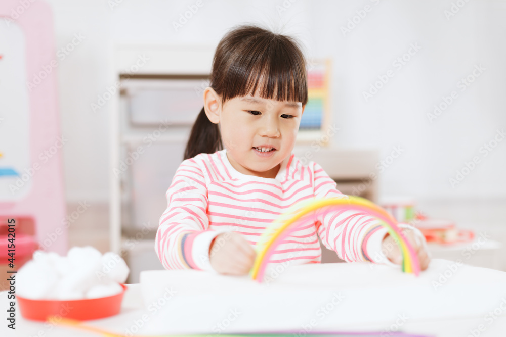 young girl making rainbow craft using pipe cleaner at home young girl making rainbow craft using pipe cleaner at home