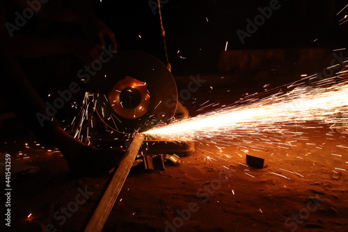 Iron cutting by iron cutter machine in night background photo