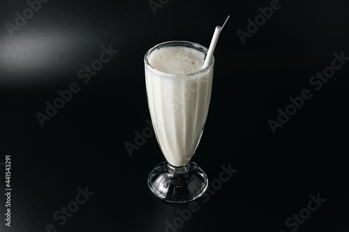 Closeup glass of milk shake isolated on black background