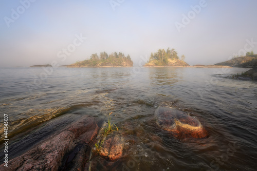 Foggy and sunny evening on a lake with islands