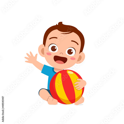 cute little baby boy playing with big ball
