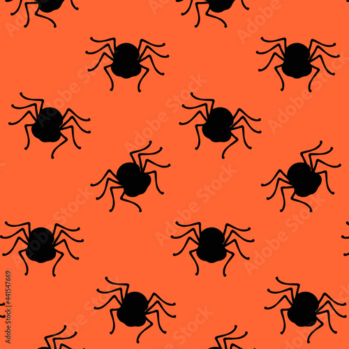 Halloween pattern in the form of a black Spider on an orange background.halloween party decorations © Anna