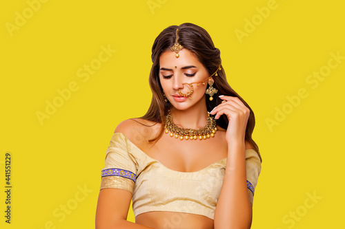 Close up Beauty Portrait indian girl.  Jewelry. Young Hindu woman model with kundan jewelry set. Red lips. Close up. Traditional India costume lehenga choli or sari. make-up    