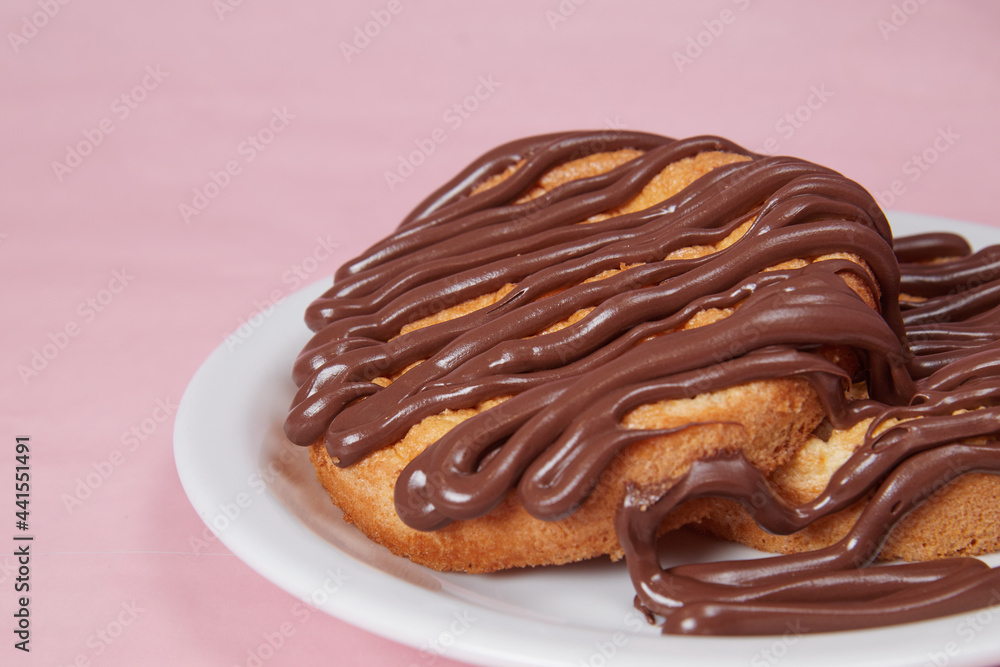 fresh pancake in a plate poured with chocolate paste, cream on buns, pancakes with chocolate fresh pancake in a plate poured with chocolate paste, cream on buns, pancakes with chocolate