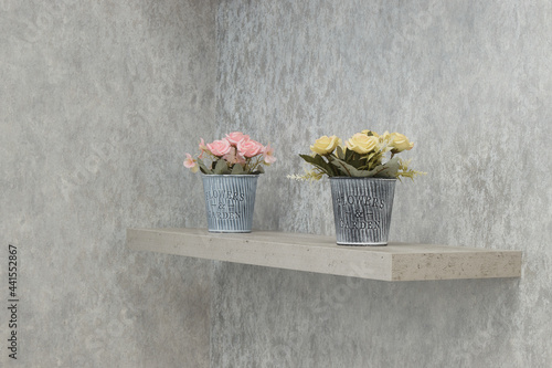 artificial flowers in a pot on a shelf, interior decoration, minimalistic decor