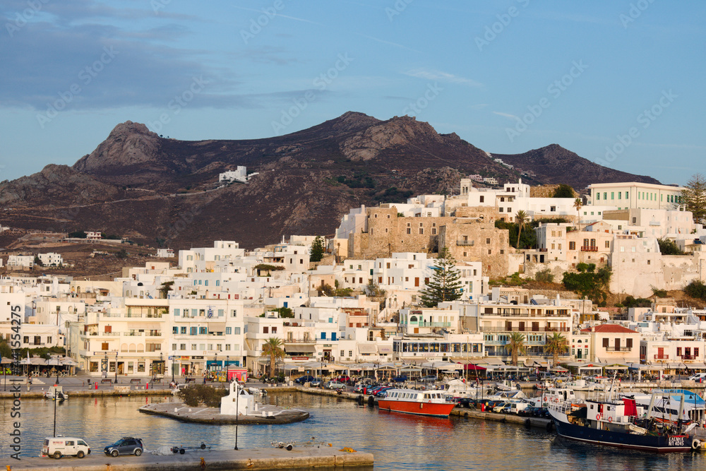 Beautiful Naxos island, Greece. Landscape with view of the historic old town. Dusk with soft light and pastel shades. Blue sky and copy space.