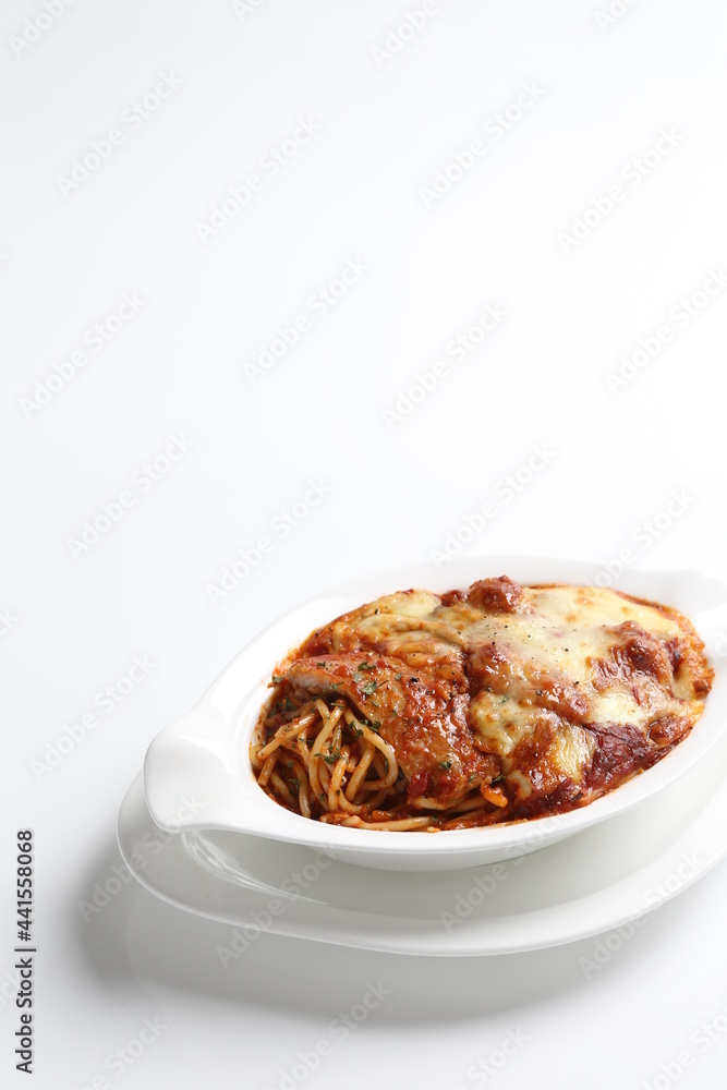 oven baked creamy cheese tomato Bolognese pasta with grilled chicken chop in bowl western chef cuisine seafood menu in white and brown background oven baked creamy cheese tomato Bolognese pasta with grilled chicken chop in bowl western chef cuisine seafood menu in white and brown background