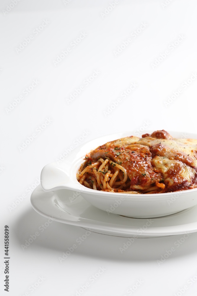 oven baked creamy cheese tomato Bolognese pasta with grilled chicken chop in bowl western chef cuisine seafood menu in white and brown background oven baked creamy cheese tomato Bolognese pasta with grilled chicken chop in bowl western chef cuisine seafood menu in white and brown background
