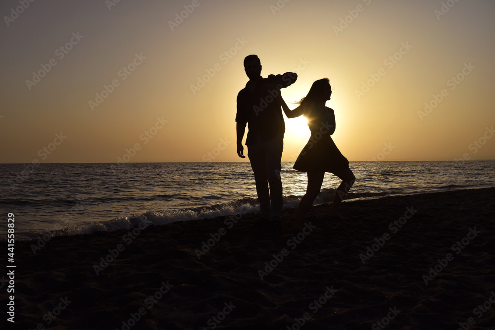 Couple on the Beach Dancing at Sunset