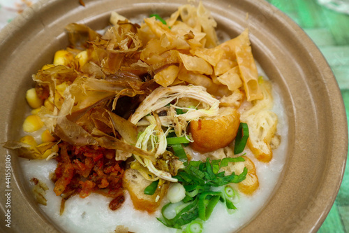 " Delicious congee served on hot claypot topped with chicken, sweet corn, skipjack tuna, tofu, green onions, crackers, dumplings and broth" 