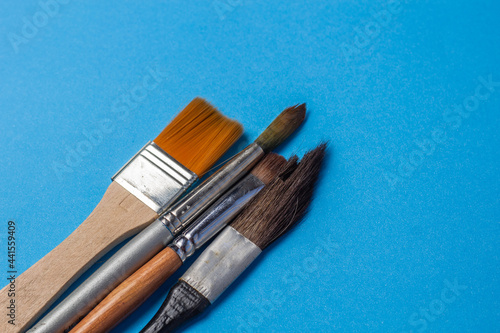 Assorted brushes on colored background