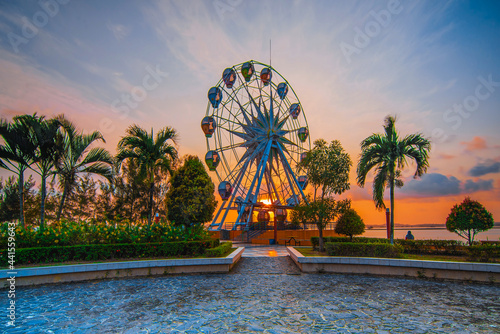 Ferris wheel at Amazing sunrise  on ocarina beach  Batam Island 