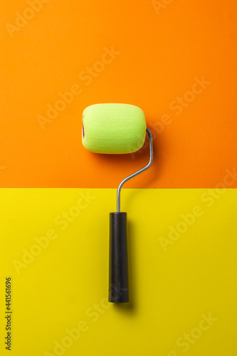 paint roller on orange and yellow background
