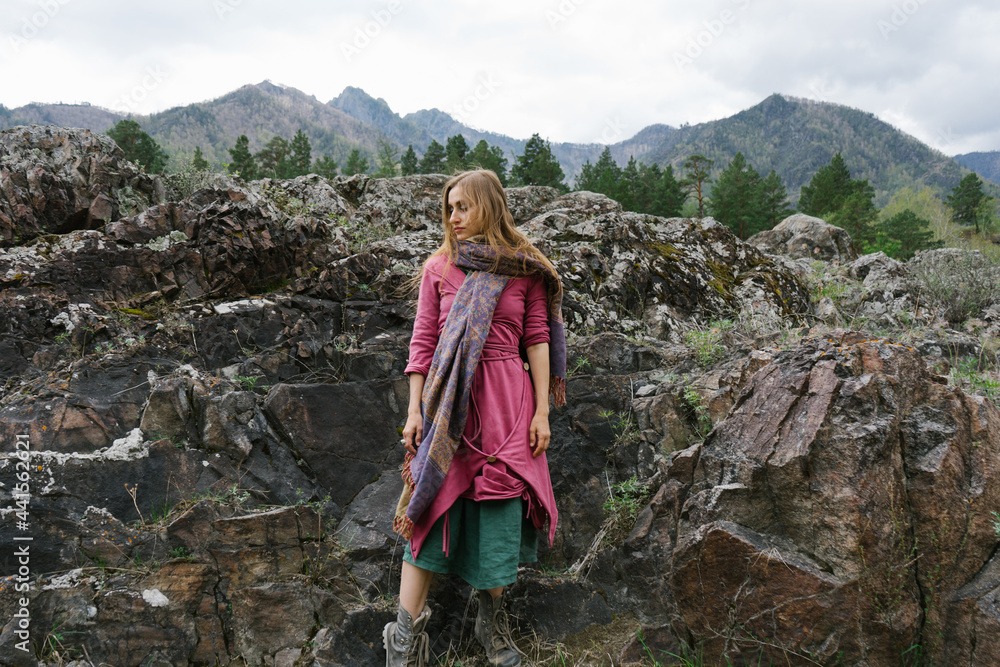 Beautiful woman wearing bright colored ethnic clothes in the mountains Beautiful woman wearing bright colored ethnic clothes in the mountains