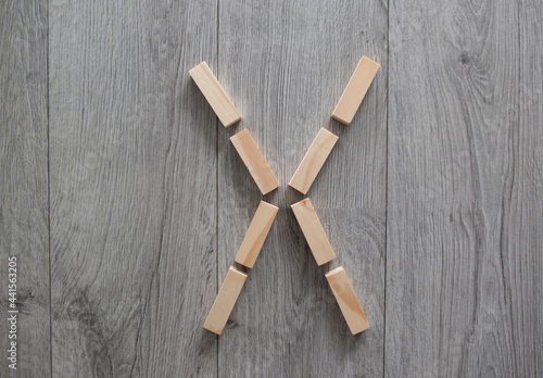 letter X natural wooden blocks on floor alphabet lettering