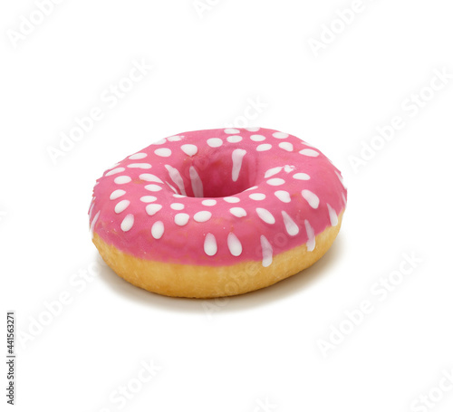 baked round donut with pink icing and white dots isolated on white background
