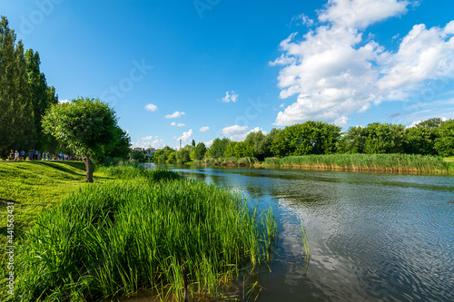 Fototapeta Naklejka Na Ścianę i Meble -  Embankment of the Tsna River in Tambov. View on flow Tsna river in Tambov city