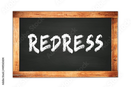 REDRESS text written on wooden frame school blackboard. photo