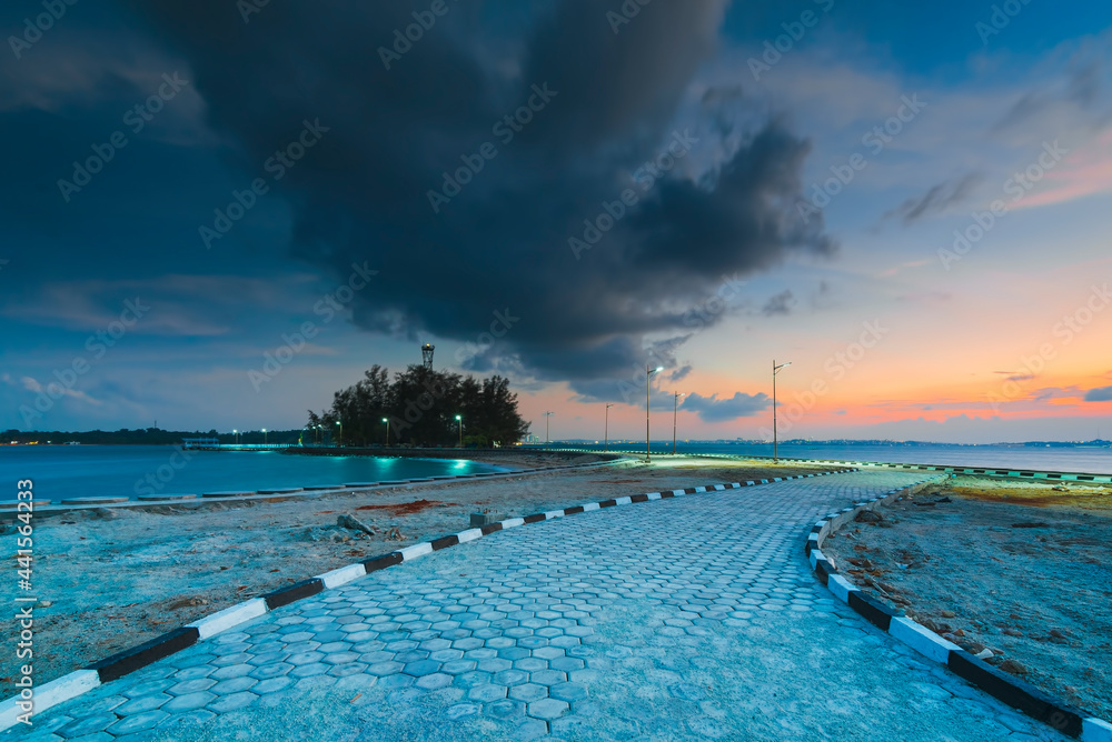Amazing sunset on the pier of Putri Island, Stone on beach  Batam Island