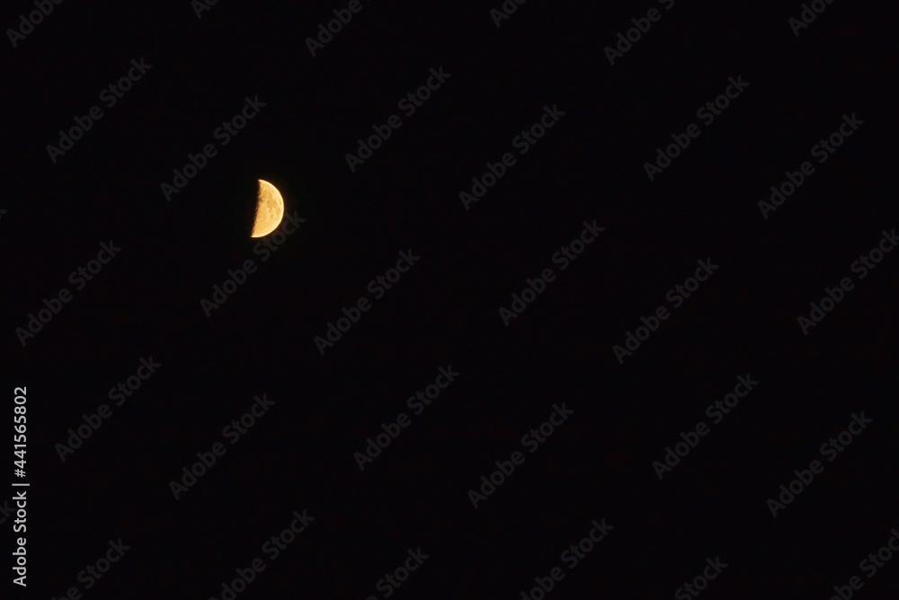 Half moon in the dark sky.Night Evening Sky Blue Moon.Copy space.Soft focus.Blurred image.