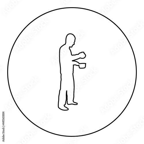 Man with saucepan in his hands preparing food Male cooking use sauciers with open lid silhouette in circle round black color vector illustration contour outline style image photo