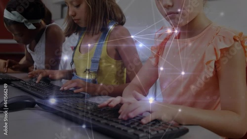 Glowing network of connections against group of diverse students using computer at school photo