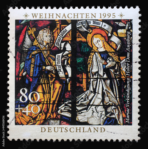 A stamp printed in Germany shows the Annunciation  Stained glass windows in Augsburg Cathedral  circa 1995