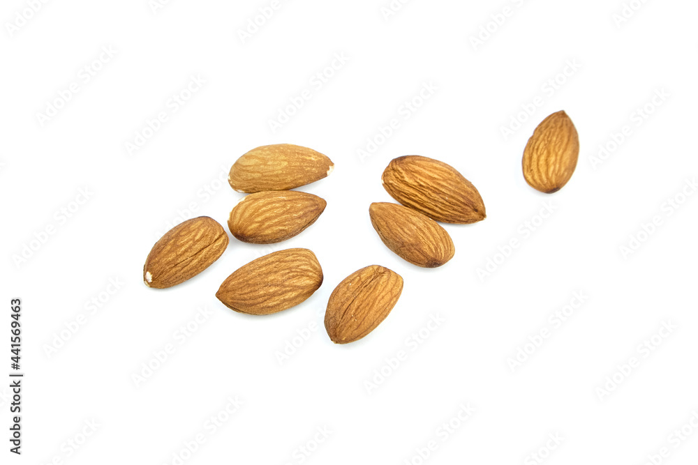 Almond nuts isolated on white background. Heap of scattered almonds Almond nuts isolated on white background. Heap of scattered almonds