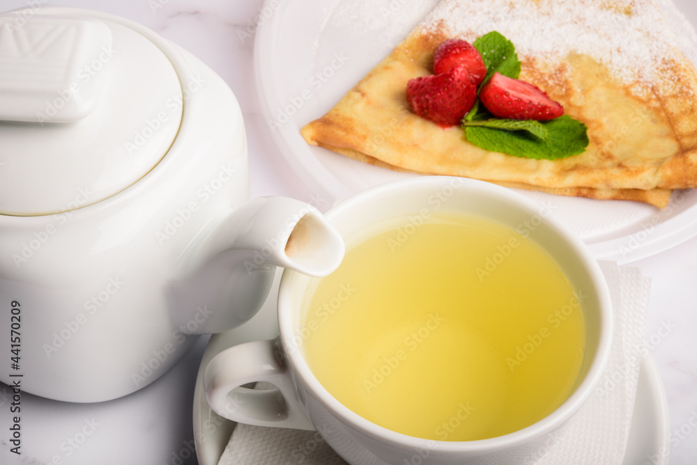 Breakfast with green tea and strawberry pancake. Breakfast with green tea and strawberry pancake.