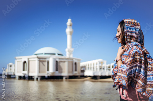 female traveler enjoying view of mosque photo