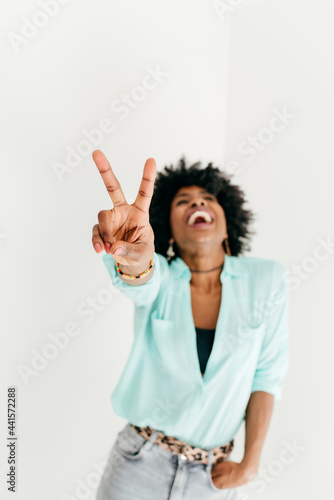 Cheerful woman showing peace sign photo