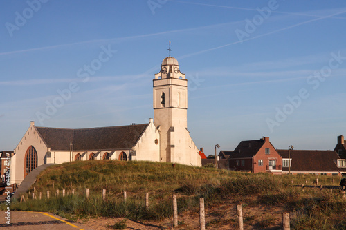 White reformed church at the dunes at Katwijk beach photo