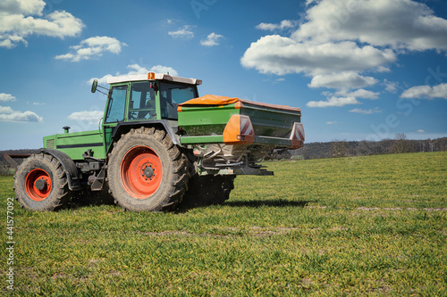 Motive aus der Landwirtschaft -Agrarpolitik. Landwirt d  ngt sein Getreide im Fr  hjahr mit Minerald  nger.