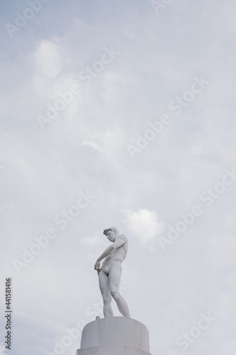 White sculpture on the background of a blue sky with clouds © Ivan Babydov