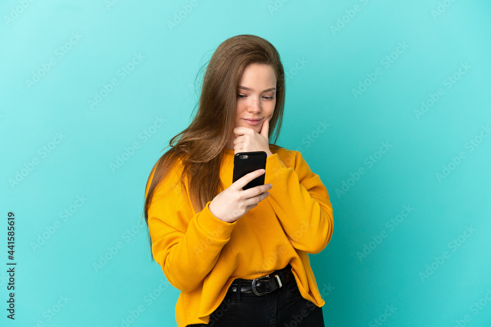 Teenager girl over isolated blue background thinking and sending a message Teenager girl over isolated blue background thinking and sending a message