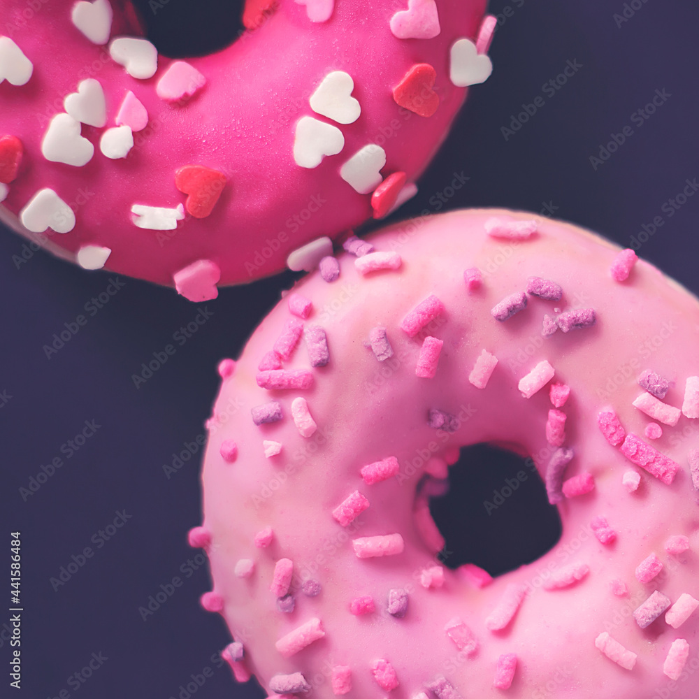 Top view of delicious cute pink donuts with sprinkles in the form of hearts. A pleasant and romantic gift for Valentine's day. Top view of delicious cute pink donuts with sprinkles in the form of hearts. A pleasant and romantic gift for Valentine's day.