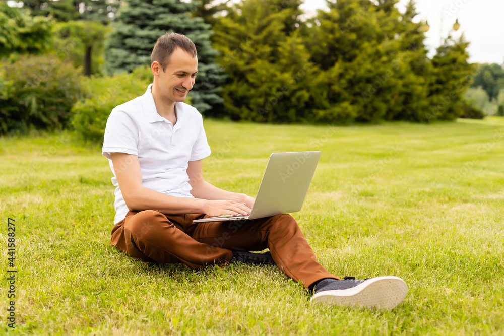 Man working on his laptop in the park Man working on his laptop in the park