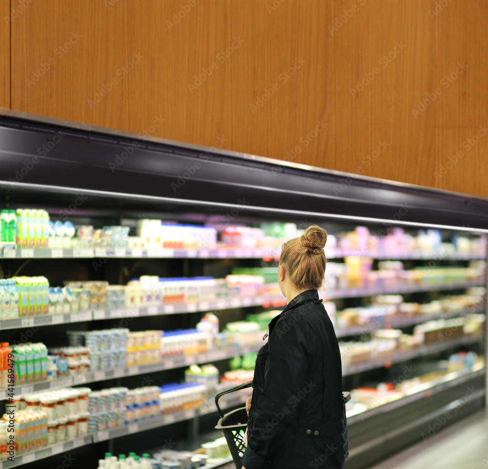 Woman choosing a dairy products at supermarket