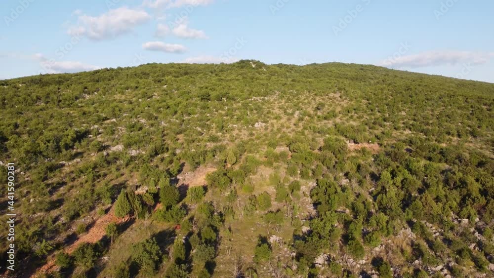 Aerial drone view of Apparition hill in Medjogorje, Bosnia and Herzegovina. Worn Path to a religious pilgrimage. Međugorje. Aerial drone view of Apparition hill in Medjogorje, Bosnia and Herzegovina. Worn Path to a religious pilgrimage. Međugorje.